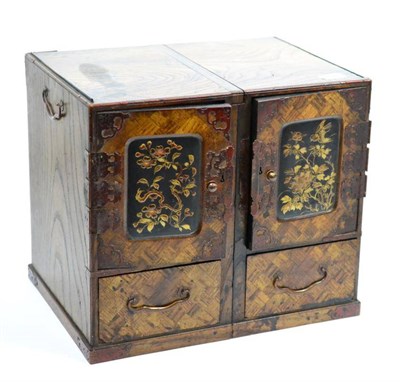 Lot 661 - A 19th century Chinese miniature elm table cabinet with two cupboard doors enclosing small drawers