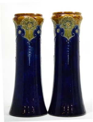 Lot 673 - A pair of Royal Doulton blue ground stoneware vases, height 33cm and a Royal Doulton blue...