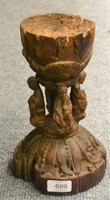 Lot 699 - A carved wood chalice, probably 14th century, the leaf sheathed bowl and plinth divided by four...