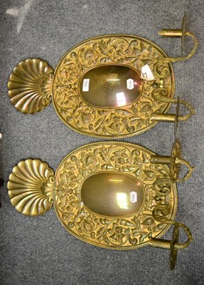 Lot 700 - A pair of 18th century mirrored brass twin light wall sconces surmounted by a shell