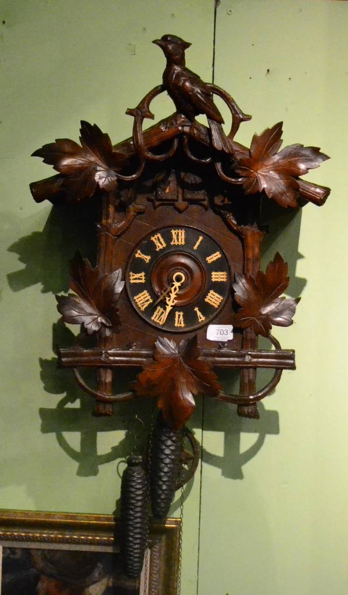 Lot 703 - A Black Forrest cuckoo striking wall clock, circa 1890, floral and bird mounts, two cuckoo door...