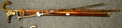 Lot 734 - An early 20th century rosewood walking stick, the horn handle carved with rats; another,...