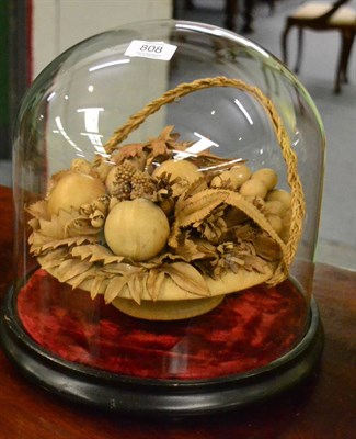 Lot 808 - A Victorian leather nut and fruit display with ebonised base and glass dome