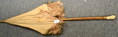 Lot 809 - A late 19th Century Ivory handled parasol, probably French the handle carved as young boy wearing a