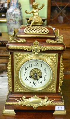 Lot 819 - A mahogany and gilt metal mounted striking table clock, circa 1900, surmounted by a cherub, pierced