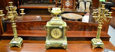 Lot 820 - A green onyx and gilt metal mounted mantel clock with garniture, circa 1910, urn finial, scroll...