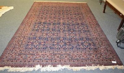 Lot 1216 - A Tabriz carpet, Iranian Azerbaijan, the indigo lattice field of curling leaves, vines and...