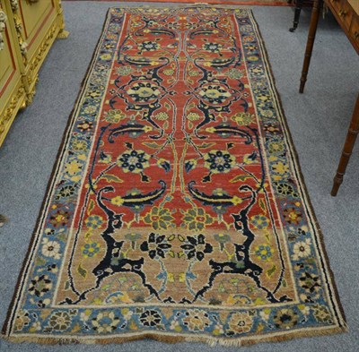 Lot 1218 - A Khoi runner, Persian Azerbaijan, the madder field of vines and flowerheads enclosed by mid indigo