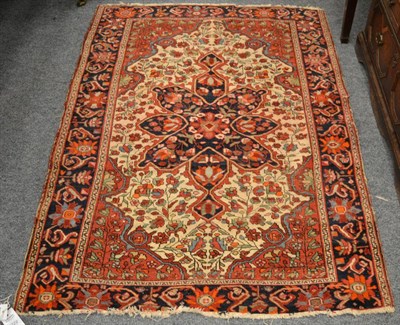 Lot 1222 - A Saroukh rug, West Iran, the ivory field of angular vines centred by an indigo medallion framed by