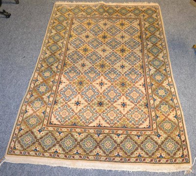 Lot 1224 - A Kashan rug, Central Persia, the ivory diamond field enclosed by a similar border, 163cm by 108cm