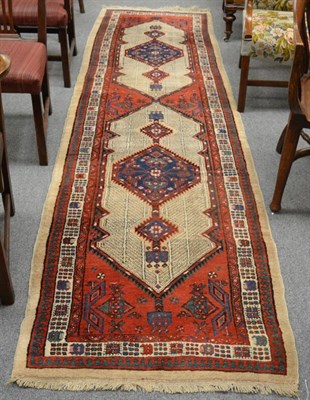 Lot 1226 - Narrow Sarab Runner, Persian Azerbaijan, the madder field with two lozenge medallions framed by...