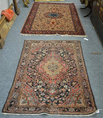 Lot 1230 - Good Saroukh rug, West Persia, the pale camel field of scrolling leafy vines around a crimson...