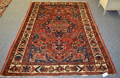 Lot 1231 - Bakhtiari rug, West Persia, the madder field of angular vines centred by an indigo medallion framed