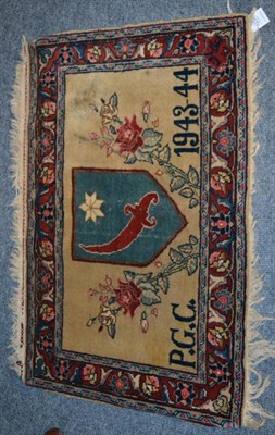 Lot 1232 - A Tabriz rug, Iranian Azerbaijan, The pale wheat field centred by a heraldic shield flanked by...