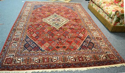 Lot 1238 - A Joshaghan carpet, Central Iran, The burgundy lattice field of stylised plants centred by a...