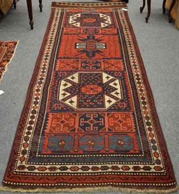 Lot 1240 - An East Anatolian runner, The compartmentalised madder field with octagons and a cruciforn...