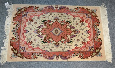 Lot 1243 - A Tabriz rug, Iranian Azerbaijan, the salmon pink field of vines around a pole medallion framed...