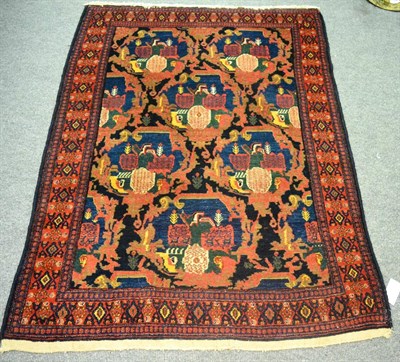 Lot 1249 - A finely woven Senneh rug, Persian Kurdistan, the indigo lattice field of scrolling vines...