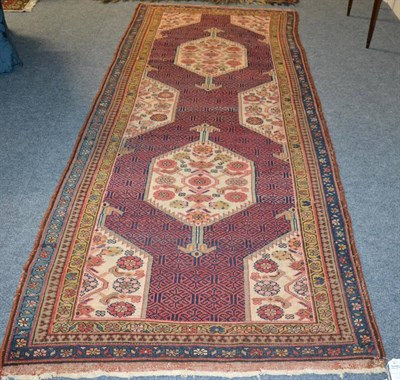 Lot 1253 - Malayir rug, the indigo honeycomb lattice field containing hooked guls centred by twin ivory...