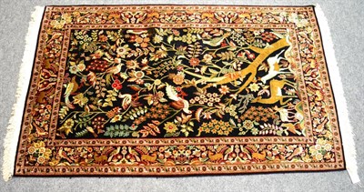 Lot 1260 - A good Kashmir silk rug, North West India, the indigo field with tree of life birds and animals...