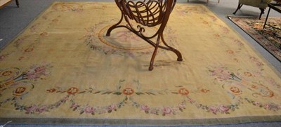 Lot 1266 - Savonnerie design carpet, the pale lemon field centred by a floral roundel enclosed by spandrels of