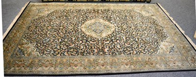 Lot 1268 - A good Kashmir silk carpet, the indigo ground centred by an ivory medallion framed by spandrels and