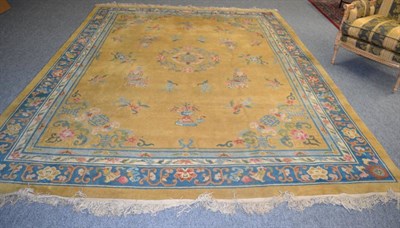 Lot 1276 - A Peking carpet, East China, the lemon field of Taoist motifs centred by a roundel framed by...