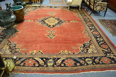 Lot 1283 - Sultanabad carpet, West Persia, the plain soft strawberry field centred by an indigo and ivory...