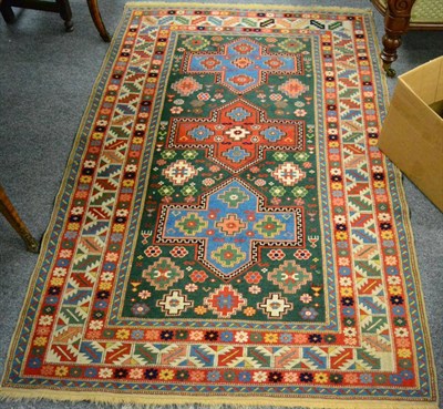 Lot 1287 - A good Shirvan design rug, West Anatolia, the bottle green field with three cruciform...