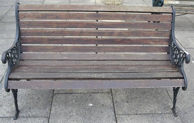 Lot 1312 - A matched pair of cast iron garden benches, with wooden slats, 149cm wide and 127cm wide