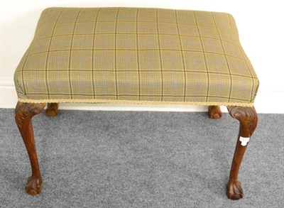 Lot 1324 - A large upholstered walnut stool with claw and ball feet