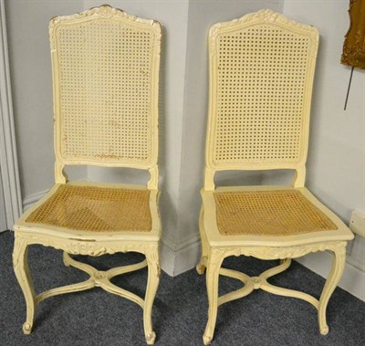 Lot 1325 - A set of six beech and white painted cane dining chairs