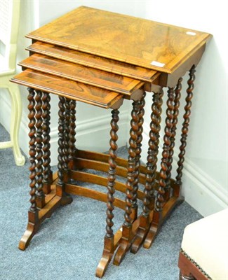 Lot 1329 - A nest of early 19th century walnut Quartetto tables with cross-banded tops and herringbone banding