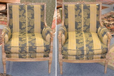 Lot 1357 - A pair of feather filled gilded armchairs, in the Louis XVI style