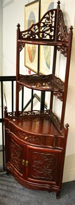 Lot 1358 - A Chinese hardwood free-standing corner cabinet with graduated shelves