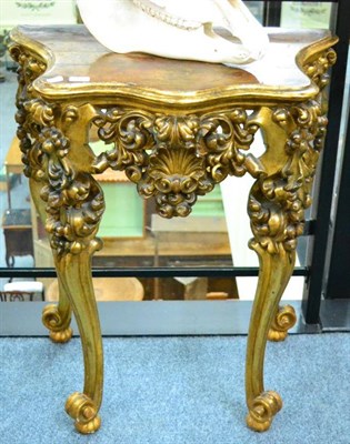 Lot 1363 - A pair of late 18th century Italian gilt serpentine shaped tables, raised on cabriole legs,...