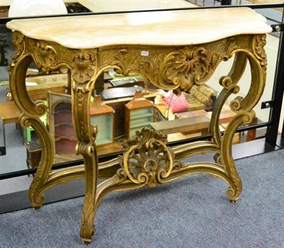 Lot 1364 - A gilt and gesso console table with Egyptian alabaster top, raised on C scroll legs joined by a...