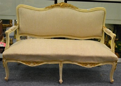 Lot 1372 - A 19th century French style cream and gilt painted settee, later re-covered in beige cotton fabric