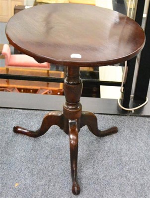 Lot 1374 - ^A George III oak tilt top circular table, with later top (the base circa 1790)