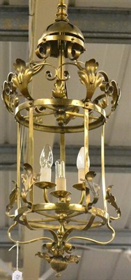 Lot 1382 - An Edwardian brass hall lantern, with leaf and scroll decoration, 77cm high, fitted for electricity