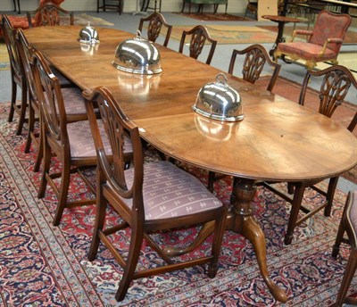 Lot 1383 - A late 19th/early 20th century walnut triple pillar dining table with three additional leaves,...