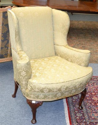 Lot 1386 - A pair of late 19th century wing back chairs, later re-covered in olive green silk fabric