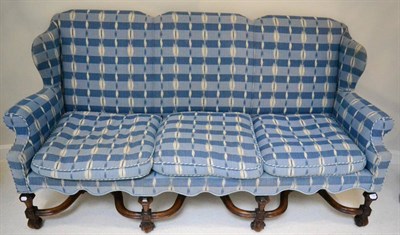 Lot 1393 - A walnut framed sofa in the 17th century style, re-covered in blue check fabric with squab...