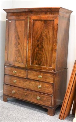 Lot 1402 - A George III mahogany linen press, with dentil cornice, converted to a wardrobe