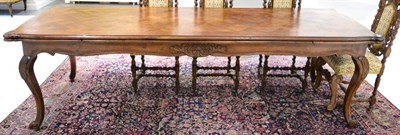 Lot 1412 - A 19th century French walnut and parquetry decorated extending dining table on carved cabriole legs