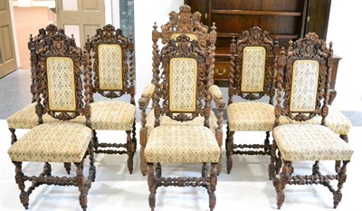 Lot 1413 - A set of eight (7 + 1) oak dining chairs with upholstered tapestry seats and back panels