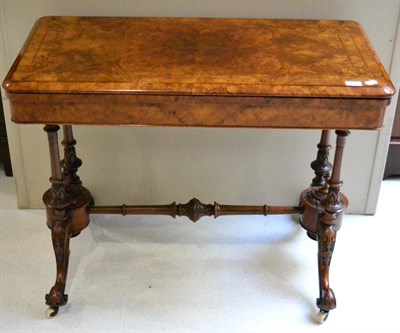 Lot 1415 - #Victorian burr walnut fold over card table on turned legs joined by a stretcher