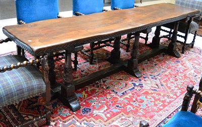 Lot 1419 - A Continental walnut refectory table with carved frieze raised on six baluster carved supports...