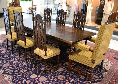 Lot 1426 - An impressive 20th century carved oak dining table, the rectangular top with cleated ends above...