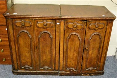 Lot 1433 - A Victorian pair of walnut side cabinets with moulded panel doors enclosing four drawers